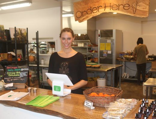 A woman serving customers at the counter of Sweet Cane Cafe in Hilo, Hawaii