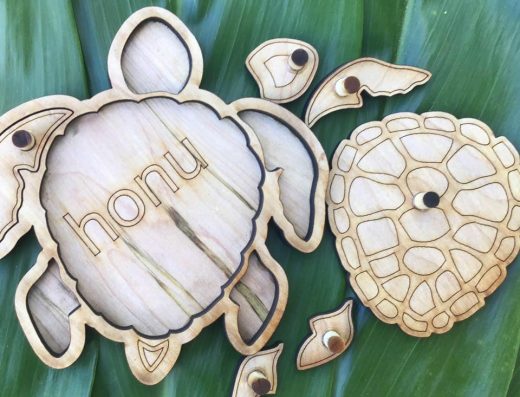 Hawaiian-themed laser-cut wooden learning puzzle created by Michael Nizo of Nizo Natural Precision in Hilo, Hawaii, designed to teach about Hawaiian culture and history.