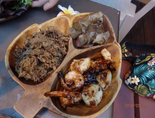 Traditional Hawaiian food at Kanaka Kava Bar in Kona, including Kalua Pork served with sides.