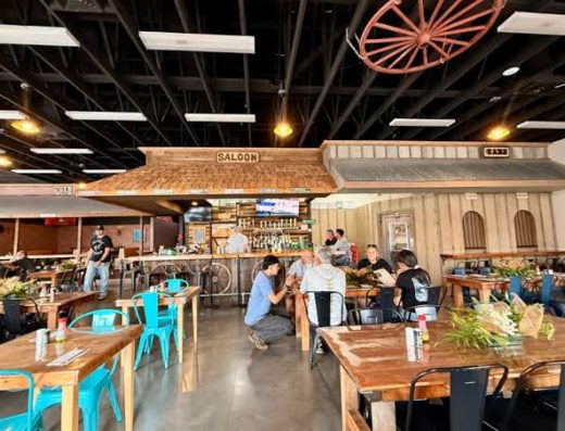 Interior dining room at Marzo's Country Sports Bar & Grill in Pāhoa, Hawaiʻi, featuring rustic country décor, spacious seating, a full bar, and a welcoming atmosphere for dining and live entertainment.